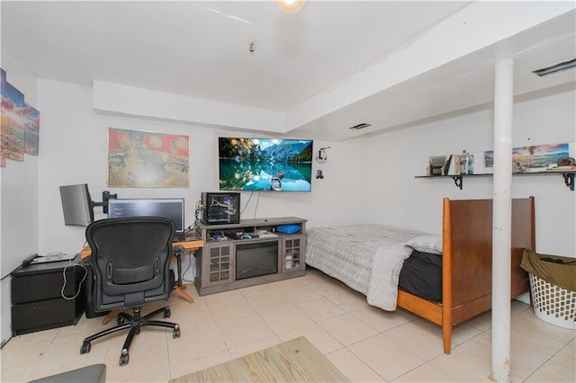 tiled bedroom featuring a desk