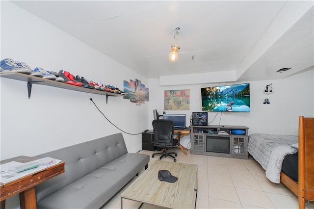 bedroom featuring tile patterned floors and a desk