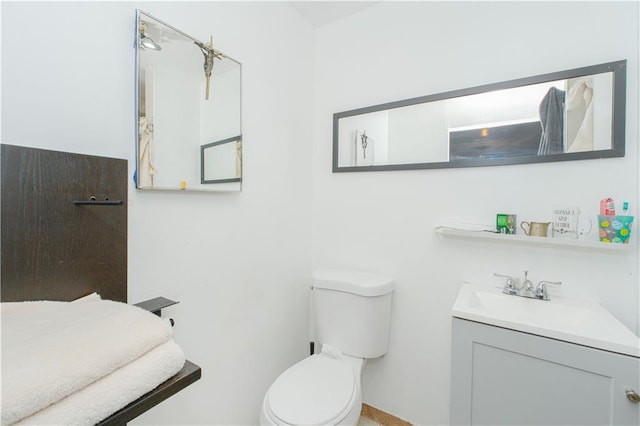 half bathroom featuring toilet and vanity