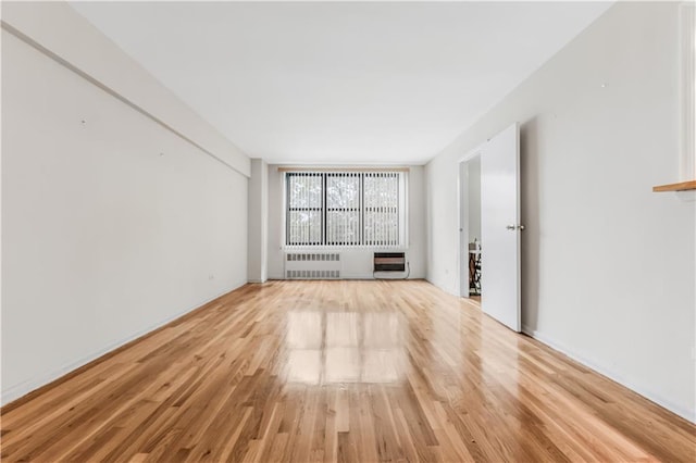 1165 54th St Unit 5U, Brooklyn, NY 11234 - empty room with radiator heating unit, light wood-type flooring, and heating unit