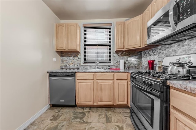 1165 54th St Unit 5U, Brooklyn, NY 11234 - kitchen with stainless steel appliances, light brown cabinetry, a sink, backsplash, and baseboards