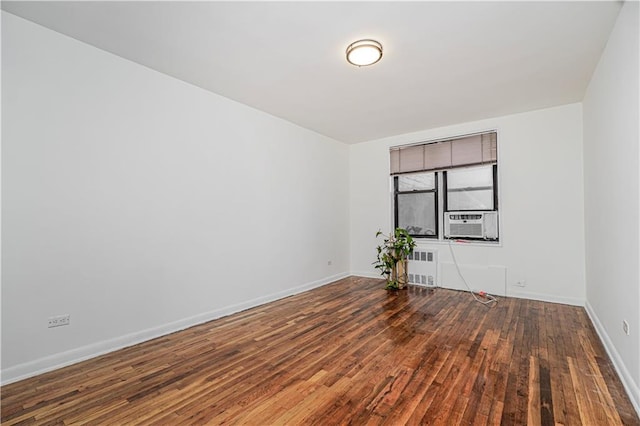 3101 Ocean Pkwy Unit 3H, Brooklyn, NY 11235 - spare room with hardwood / wood-style floors, baseboards, radiator heating unit, and cooling unit