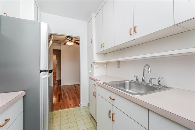 3101 Ocean Pkwy Unit 3H, Brooklyn, NY 11235 - kitchen with freestanding refrigerator, a sink, light countertops, ceiling fan, and white cabinetry