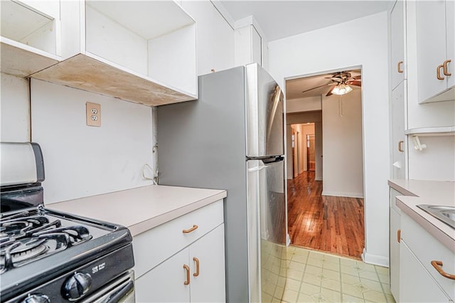 3101 Ocean Pkwy Unit 3H, Brooklyn, NY 11235 - kitchen with range with gas stovetop, light countertops, ceiling fan, and white cabinetry
