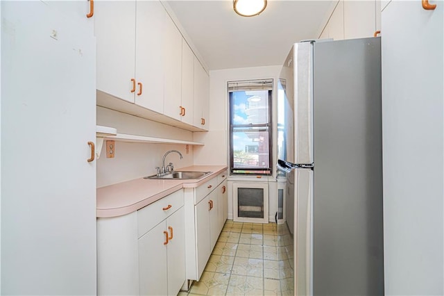 3101 Ocean Pkwy Unit 3H, Brooklyn, NY 11235 - kitchen with freestanding refrigerator, a sink, light countertops, and white cabinets