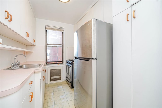 3101 Ocean Pkwy Unit 3H, Brooklyn, NY 11235 - kitchen featuring stainless steel appliances, a sink, light countertops, and white cabinetry