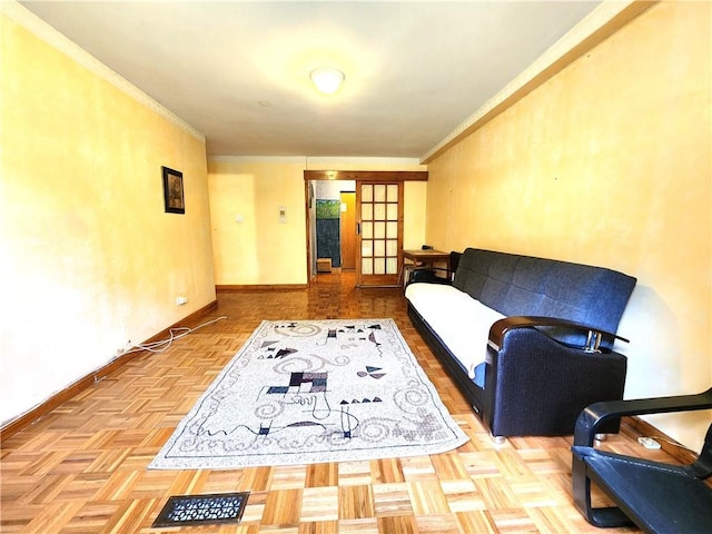 sitting room featuring baseboards and ornamental molding