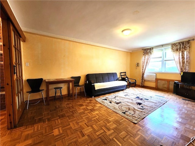 sitting room featuring crown molding and baseboards