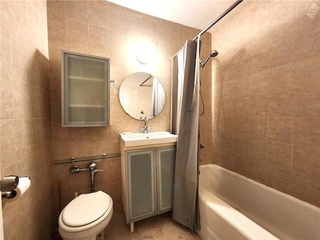 bathroom with tile walls, shower / bath combo with shower curtain, toilet, vanity, and tile patterned flooring