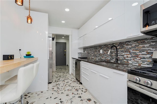 2546 E 13th St Unit A11, Brooklyn, NY 11235 - kitchen featuring stainless steel appliances, white cabinetry, tasteful backsplash, pendant lighting, and recessed lighting
