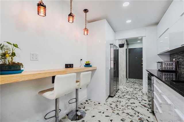 2546 E 13th St Unit A11, Brooklyn, NY 11235 - kitchen featuring white cabinetry, recessed lighting, decorative light fixtures, modern cabinets, and a kitchen breakfast bar