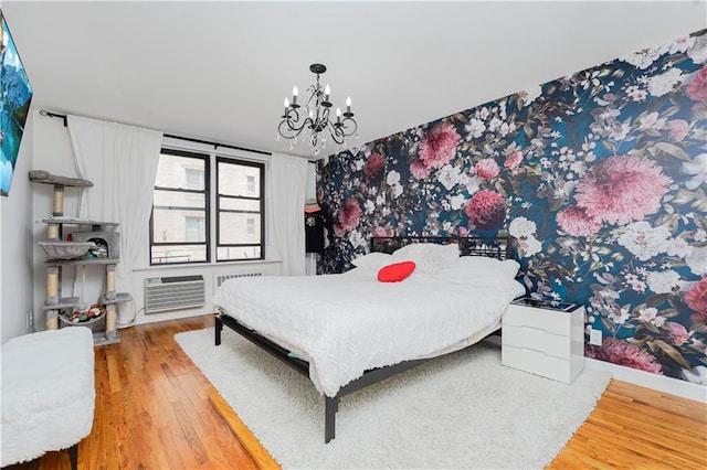 2546 E 13th St Unit A11, Brooklyn, NY 11235 - bedroom with a chandelier, wood finished floors, and a wall mounted air conditioner