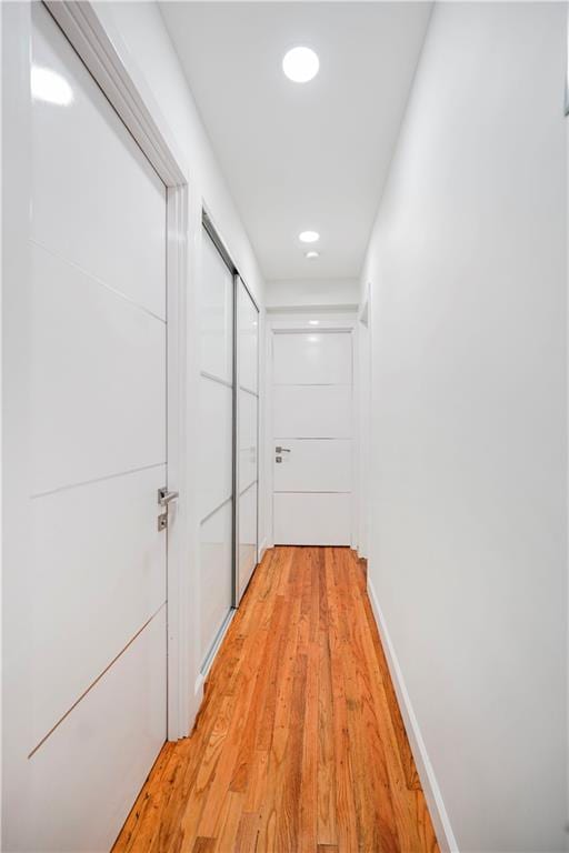2546 E 13th St Unit A11, Brooklyn, NY 11235 - hallway featuring light wood-style floors and recessed lighting