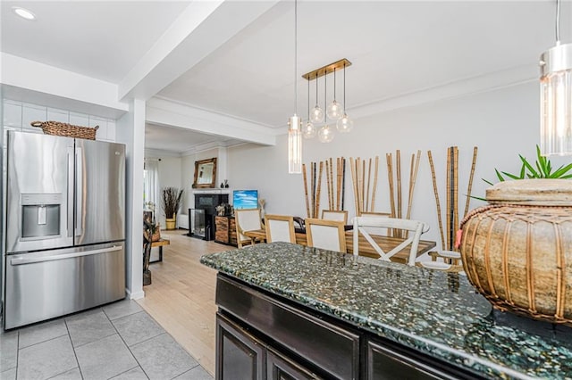 138 Wakeman Pl, Brooklyn, NY 11220 - kitchen featuring stainless steel fridge, ornamental molding, dark stone countertops, light tile patterned flooring, and pendant lighting