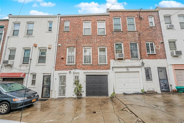 138 Wakeman Pl, Brooklyn, NY 11220 - view of property featuring driveway, brick siding, an attached garage, and cooling unit