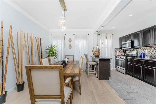 138 Wakeman Pl, Brooklyn, NY 11220 - dining room featuring light wood-style floors, ornamental molding, and recessed lighting