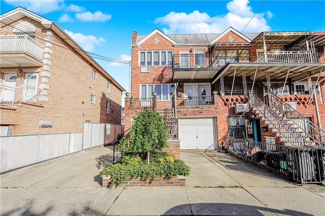 167 Bay 32nd St, Brooklyn, NY 11214 - view of property featuring brick siding, stairway, a garage, concrete driveway, and a balcony