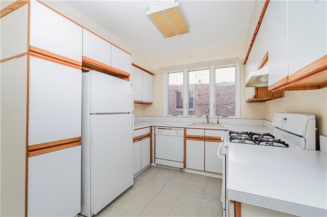 167 Bay 32nd St, Brooklyn, NY 11214 - kitchen with white appliances, light countertops, white cabinetry, under cabinet range hood, and light tile patterned flooring
