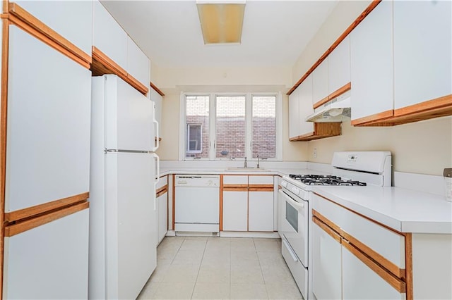 167 Bay 32nd St, Brooklyn, NY 11214 - kitchen featuring white appliances, under cabinet range hood, light countertops, white cabinets, and light tile patterned floors