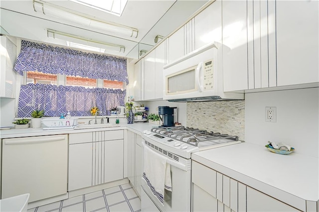 167 Bay 32nd St, Brooklyn, NY 11214 - kitchen featuring white appliances, light countertops, white cabinetry, and tasteful backsplash