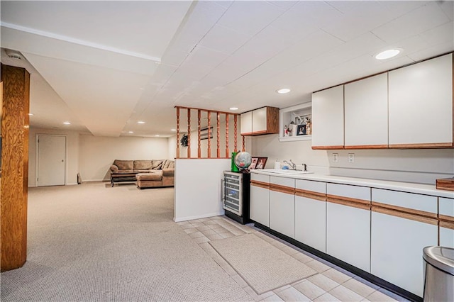 167 Bay 32nd St, Brooklyn, NY 11214 - kitchen featuring beverage cooler, recessed lighting, white cabinetry, light countertops, and light carpet