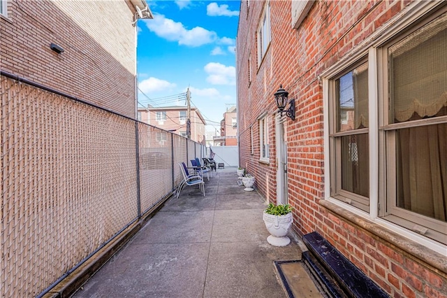 167 Bay 32nd St, Brooklyn, NY 11214 - view of side of property featuring brick siding, a patio area, and a fenced backyard