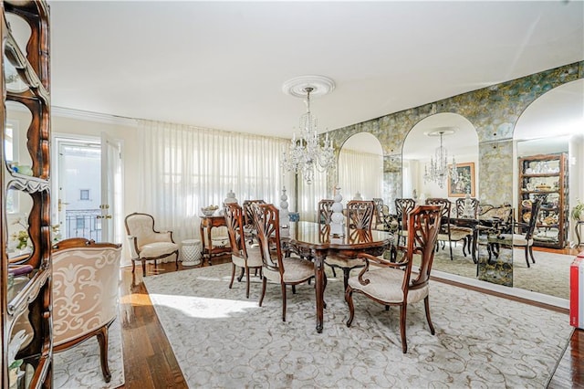 167 Bay 32nd St, Brooklyn, NY 11214 - dining space featuring a chandelier, wood finished floors, wallpapered walls, and arched walkways