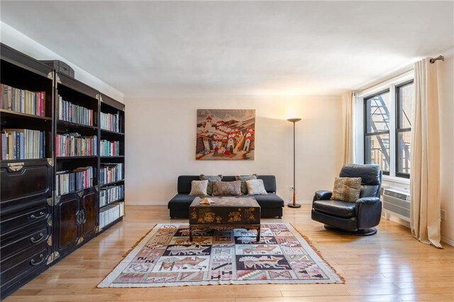 living area with wood finished floors and baseboards