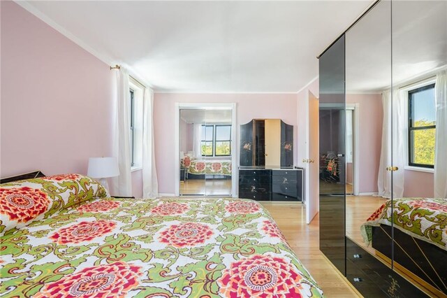 bedroom featuring wood finished floors and baseboards