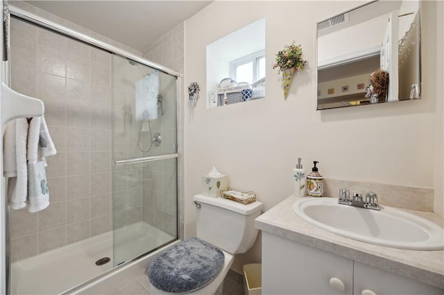 full bath featuring a stall shower, toilet, and vanity