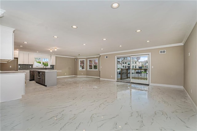 unfurnished living room with crown molding, baseboards, recessed lighting, light marble finish flooring, and a sink