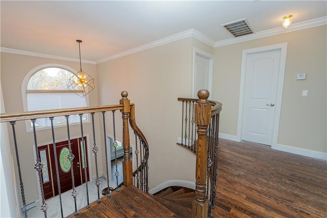 staircase with baseboards, a chandelier, ornamental molding, and wood finished floors