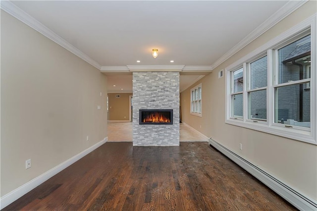 unfurnished living room with baseboard heating, dark wood-style flooring, a fireplace, ornamental molding, and baseboards