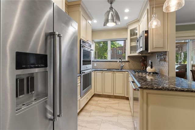 2472 Stuart St, Brooklyn, NY 11229 - kitchen with stainless steel appliances, cream cabinets, crown molding, light marble finish flooring, and backsplash