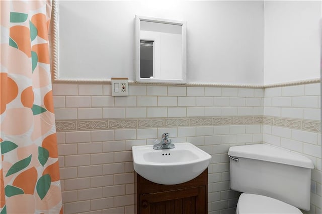 2472 Stuart St, Brooklyn, NY 11229 - bathroom featuring tile walls, vanity, curtained shower, and a wainscoted wall
