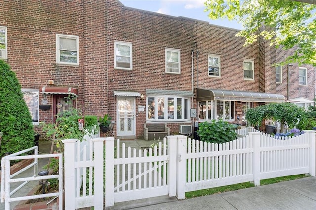 2472 Stuart St, Brooklyn, NY 11229 - view of front of property featuring a fenced front yard, brick siding, and a gate