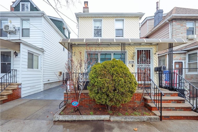 view of front of home with cooling unit and a chimney