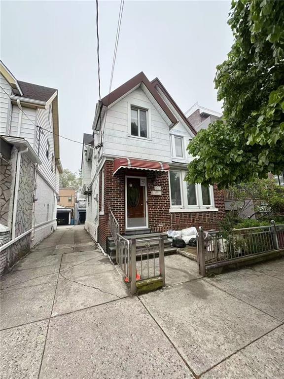 1620 68th St, Brooklyn, NY 11204 - view of front of home with a fenced front yard, brick siding, and concrete driveway