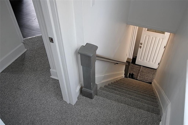 staircase with carpet flooring and baseboards