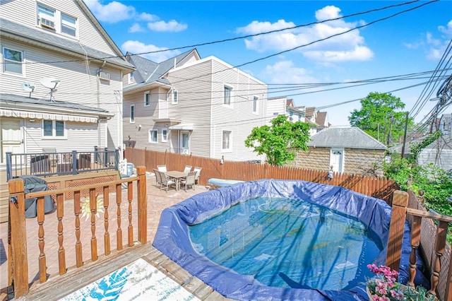 deck with outdoor dining space and a fenced backyard