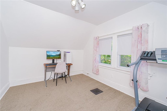 carpeted office space featuring vaulted ceiling and baseboards