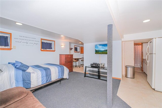 bedroom featuring freestanding refrigerator, recessed lighting, and light tile patterned flooring