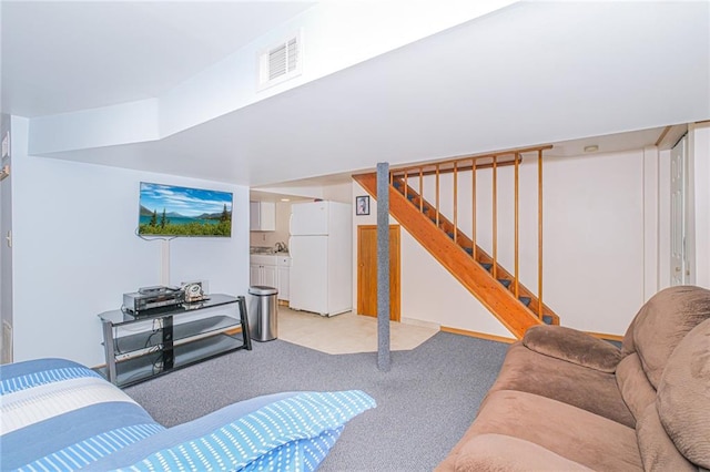 living room with light colored carpet and stairs