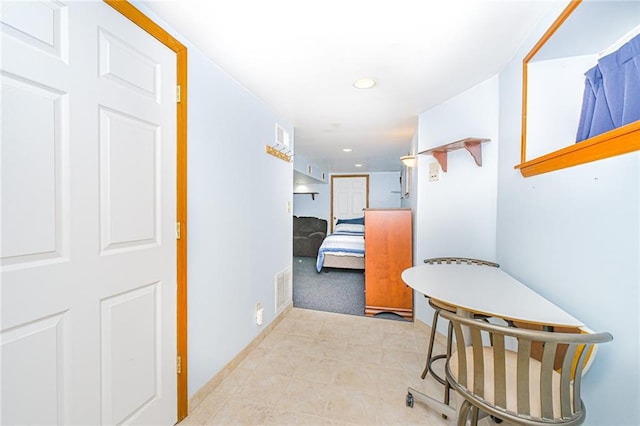 hallway featuring recessed lighting, carpet, baseboards, and tile patterned flooring