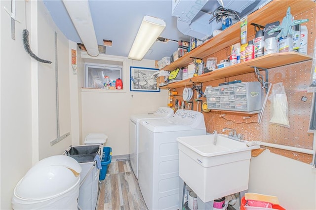 laundry room with wood finished floors and washer and dryer