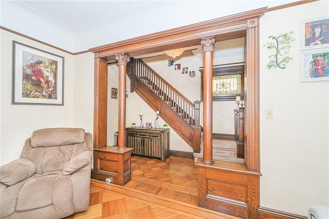 sitting room with stairs and baseboards