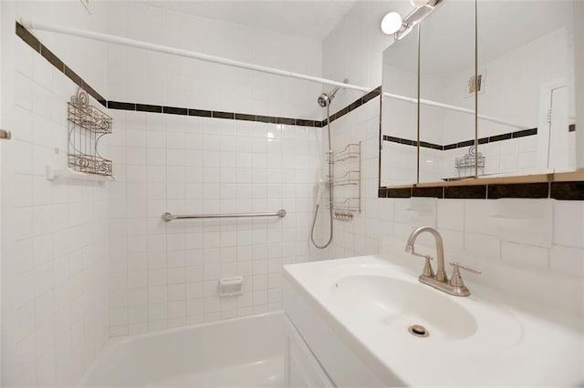 2483 W 16th St Unit 4B, Brooklyn, NY 11214 - bathroom featuring tile walls, bathing tub / shower combination, and vanity