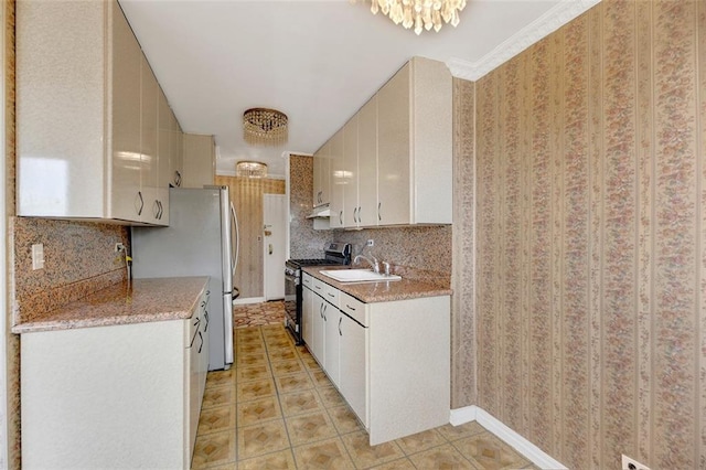 2483 W 16th St Unit 4B, Brooklyn, NY 11214 - kitchen featuring stainless steel appliances, backsplash, a sink, light tile patterned floors, and white cabinetry