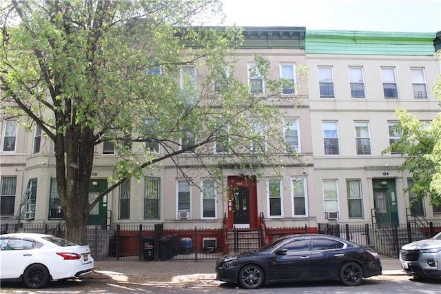 townhome / multi-family property with a fenced front yard