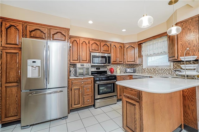 1413 81st St, Brooklyn, NY 11228 - kitchen featuring appliances with stainless steel finishes, brown cabinets, a peninsula, light countertops, and backsplash